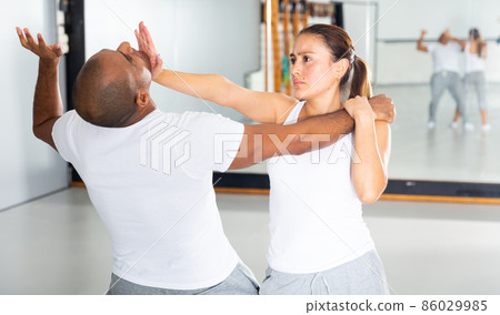 Latin american woman practicing palm strike in self defense training 86029985