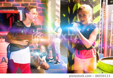 Teenagers having fun on lasertag arena 86030113
