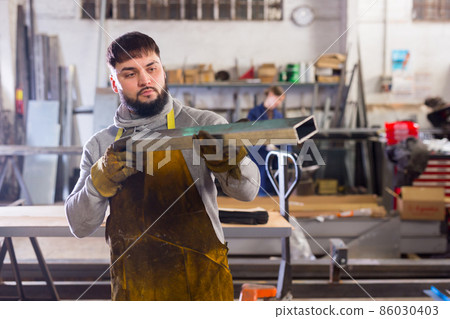 Metalworker checking metal structures Metalworker checking metal structures 86030403