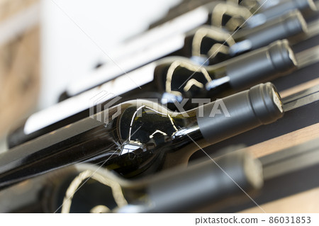 Wine bottles with blank labels on the counter of a liquor store. Wine background. Selected focus 86031853