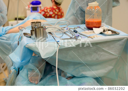 Plastic surgery to remove excess fat. Pumping fat into a jar during liposuction. Clinic of aesthetic surgery. Plastic surgery to remove excess fat. Pumping fat into a jar during liposuction. Clinic of aesthetic surgery. 86032202