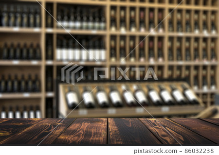 Wine wooden table background. Blurred wine shop with bottles on the counter. 86032238