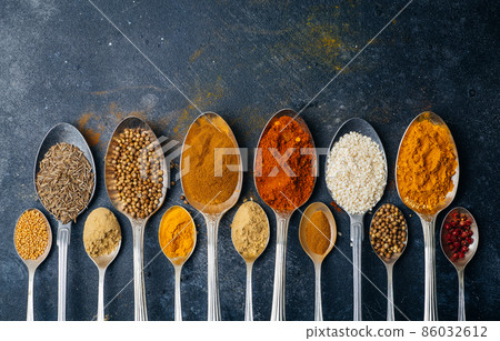 Spices in spoons background. Varieties of spices turmeric, pepper, chili, coriander, cinnamon and peppers for cooking. Culinary food concept. Spices in spoons background. Varieties of spices turmeric, pepper, chili, coriander, cinnamon and peppers for cooking. Culinary food concept. 86032612