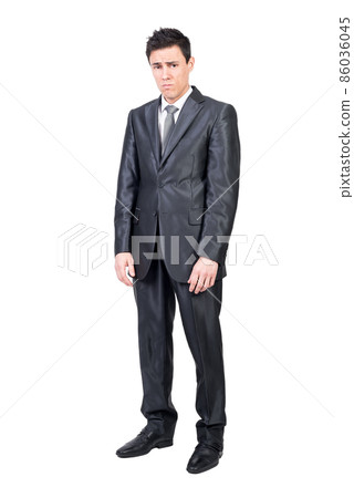 Upset young man in classy suit looking at camera 86036045