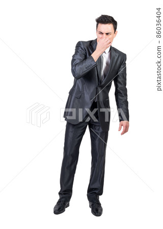 Businessman feeling bad smell in studio. White background. Businessman feeling bad smell in studio. White background. 86036404