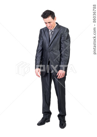 Comic businessman in suit crying in studio 86036788