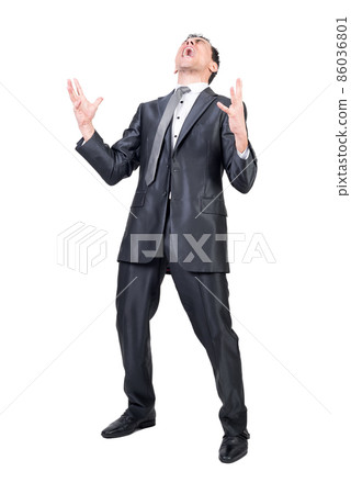 Businessman in suit shouting in studio. White background. 86036801