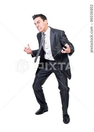 Crazy businessman in suit in studio. White background. 86036802
