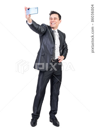 Positive businessman taking selfie on white background Positive businessman taking selfie on white background 86036804