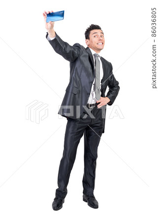 Funny businessman in suit taking selfie. White background. Funny businessman in suit taking selfie. White background. 86036805