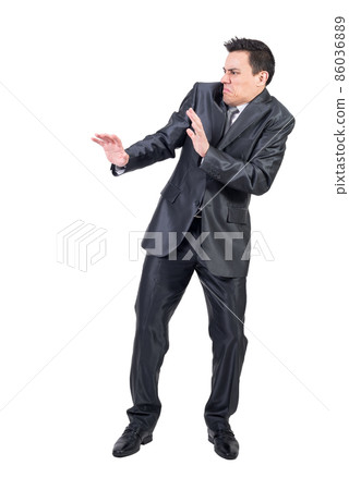 Disgusted man in elegant suit. White background. Disgusted man in elegant suit. White background. 86036889