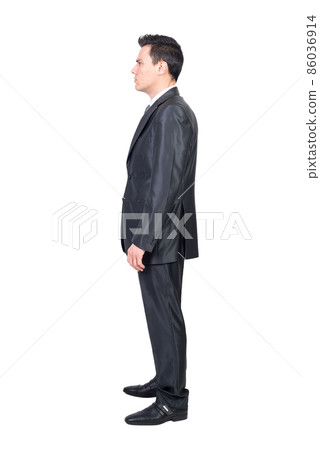 Serious male manager in suit standing in white studio Serious male manager in suit standing in white studio 86036914