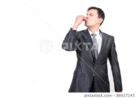 Expressive man in black suit showing delicious gesture Expressive man in black suit showing delicious gesture 86037143