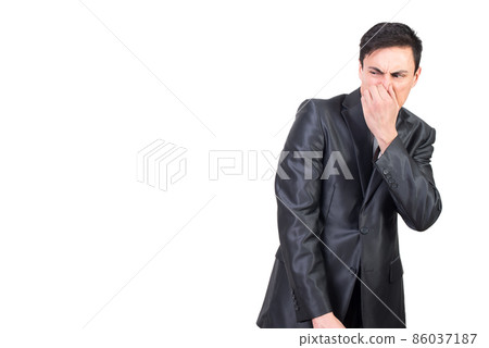 Man in elegant suit pinching nose in studio 86037187