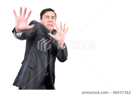 Frightened man gesturing and looking at camera with scared face 86037362