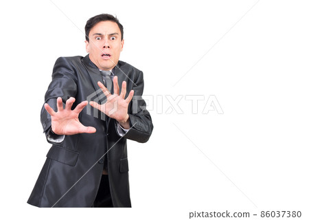 Shocked businessman gesturing and looking at camera with scared face Shocked businessman gesturing and looking at camera with scared face 86037380