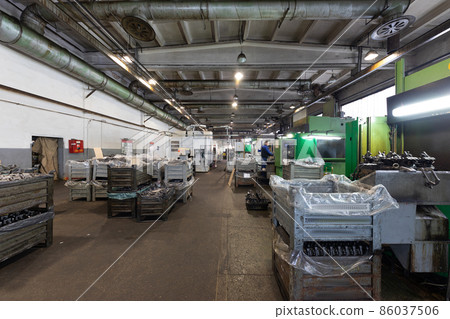 The interior of a big industrial building of factory with steel constructions. Plant of car The interior of a big industrial building of factory with steel constructions. Plant of car 86037506