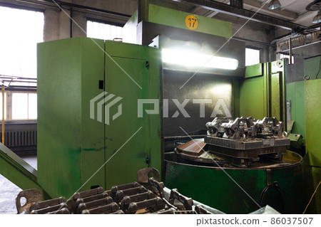 The interior of a big industrial building of factory with steel constructions. Plant of car The interior of a big industrial building of factory with steel constructions. Plant of car 86037507