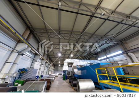 Photo shot of roll of painted galvanized steel sheet at cutting machine, ironworks and metalwork in 86037817