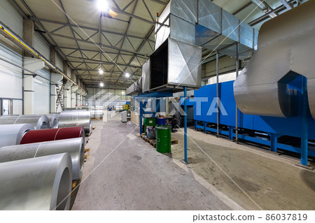 Photo of steel roofing forming machine. Industrial machine for metal sheet roof coils cut. Factory 86037819