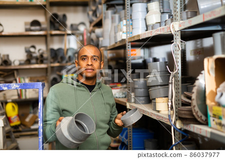 Latin american man choosing building materials in store 86037977