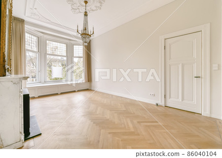 Amazing design of an empty room with a black fireplace and chandelier 86040104