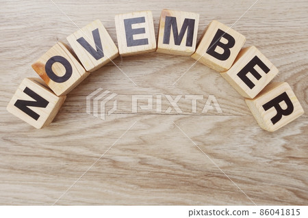 november alphabet letters on wooden background 86041815