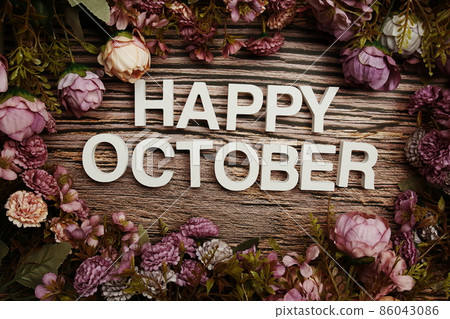 Happy October alphabet letters with flowers frame on wooden background 86043086