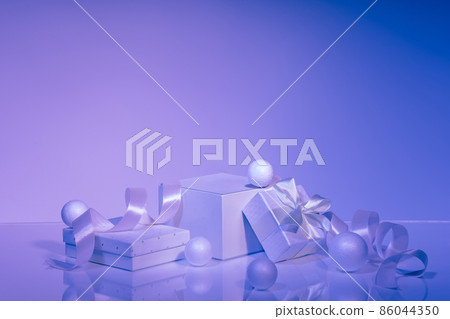 Podium and gift boxes with satin ribbon on violet background Podium and gift boxes with satin ribbon on violet background 86044350