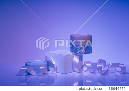 Podium and gift boxes with satin ribbon on violet background Podium and gift boxes with satin ribbon on violet background 86044351