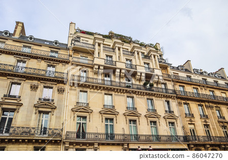 Architecture of Paris France. Facade of a traditional apartment building 86047270
