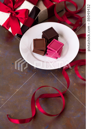 Red ribbon present box and chocolate Red ribbon present box and chocolate 86049432