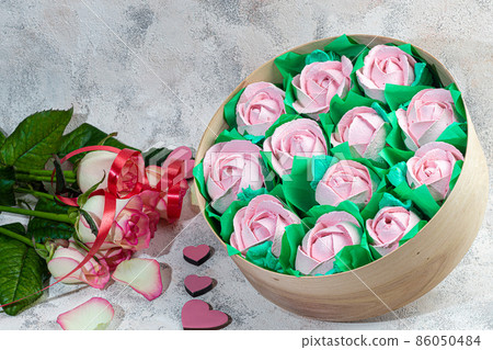 Handmade marshmallows in wooden packages on a light background with flowers. The concept of the holidays Women's Day and Valentine's Day. 86050484