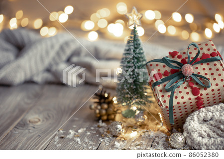 Christmas composition with a festive gift on a blurred background. 86052380