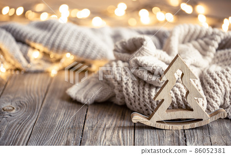 Christmas composition with wooden decorative element on blurred background. Christmas composition with wooden decorative element on blurred background. 86052381
