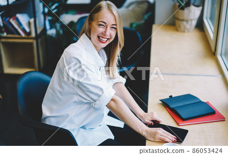 Young female with tablet laughing Young female with tablet laughing 86053424