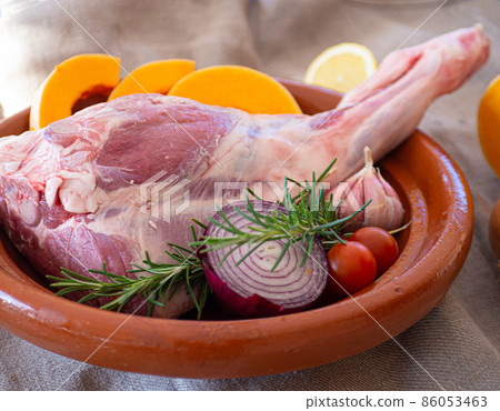 Fresh and raw meat. Leg of lamb on wood background  86053463