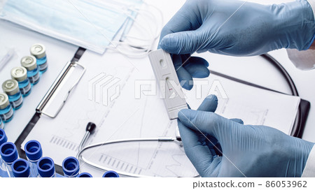 Sars test antigen coronavirus kit. Doctor holding rapid covid medical test. Laboratory hospital lab background. Patient fast swab serology antibody specimen sample. 86053962