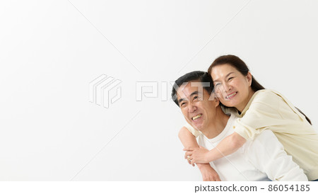 Senior couple portrait piggyback ride Senior couple portrait piggyback ride 86054185