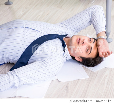 Frustrated businessman stressed from excessive work Frustrated businessman stressed from excessive work 86054416