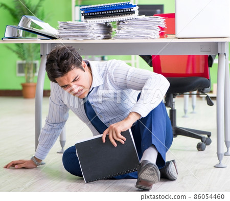 Frustrated businessman stressed from excessive work Frustrated businessman stressed from excessive work 86054460
