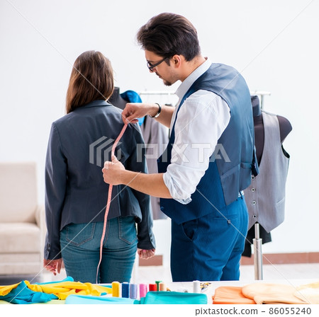 Professional tailor taking measurements for formal suit Professional tailor taking measurements for formal suit 86055240