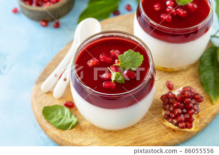 Winter panna cotta with pomegranate jelly and mint, italian dessert, homemade cuisine. 86055556