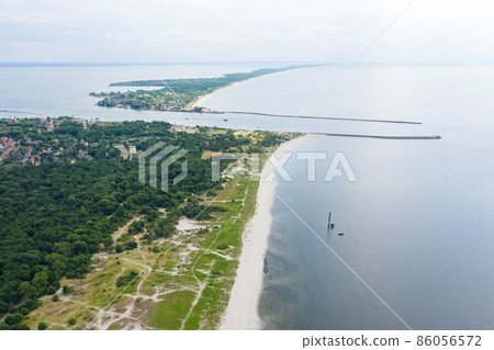 Ship goes through Strait of Baltiysk separating the Vistula Lagoon from Gdansk Bay. Aerial view Ship goes through Strait of Baltiysk separating the Vistula Lagoon from Gdansk Bay. Aerial view 86056572