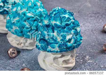 Handmade marshmallows on a light background in the form of roses, hydrangeas and tulips. There are flowers nearby. Women's day, Valentine's day. Handmade marshmallows on a light background in the form of roses, hydrangeas and tulips. There are flowers nearby. Women's day, Valentine's day. 86057137