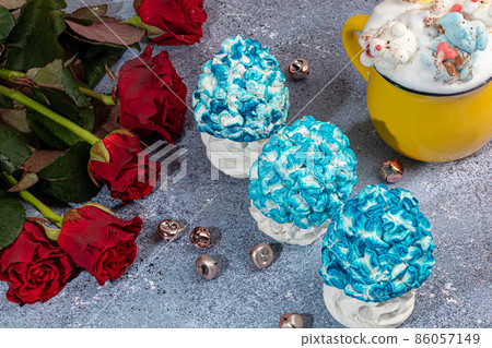 Handmade marshmallows on a light background in the form of roses, hydrangeas and tulips. There are flowers nearby. Women's day, Valentine's day. 86057149