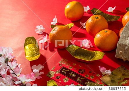 Flat lay mockup for holiday Chinese new year red packet and gold accessories blossom and Lunar festival background, means wealthy or rich and happiness. Flat lay mockup for holiday Chinese new year red packet and gold accessories blossom and Lunar festival background, means wealthy or rich and happiness. 86057535