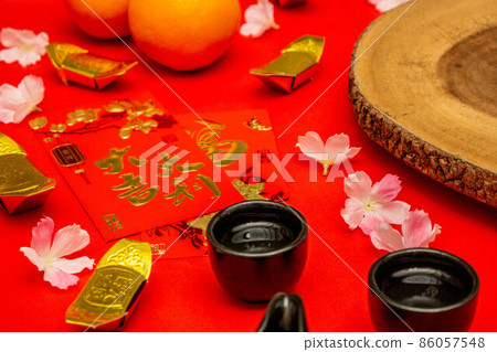 Above view accessories of Chinese new year or Mood day festival oranges gold and Angpao pockets whit cherry blossom branch decorations. 86057548