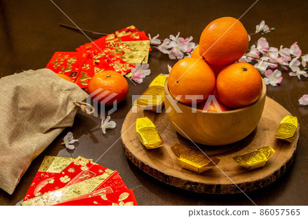 Flat lay mockup for holiday Chinese new year red packet and gold accessories blossom and Lunar festival background, means wealthy or rich and happiness. 86057565