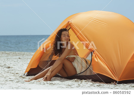 Naked Woman on the Beach in a Tent 86058592
